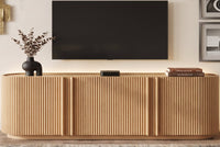 Fluted TV Stand for TVs up to 70", 66.9" Natural Oak Wood Grain Media Console with Tambour-Style Doors, Oval Curved Edge Entertainment Center with Adjustable Shelves and Cable Management, Mid-Century Modern, Natural Oak